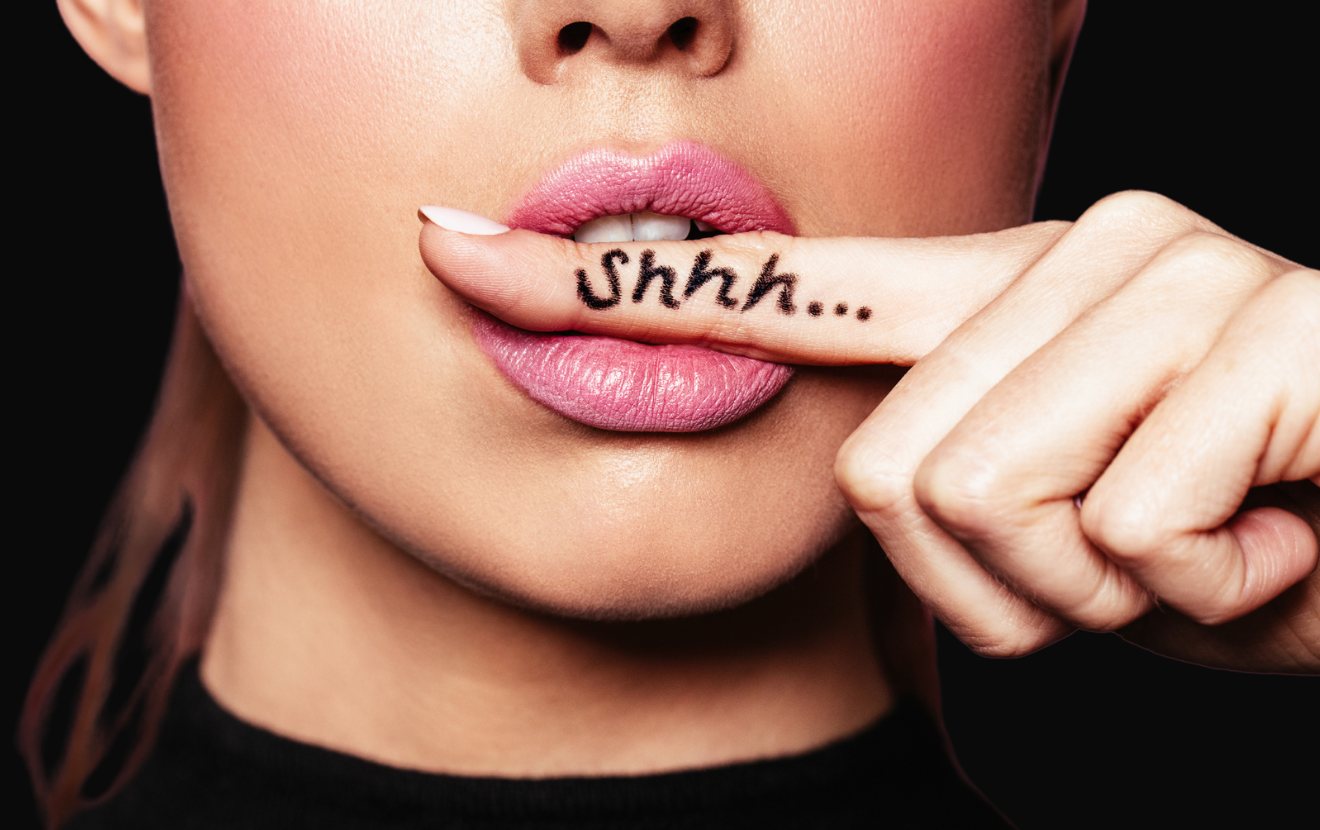 A finger held to lips with the word shhh written on it, the All Famous brand image
